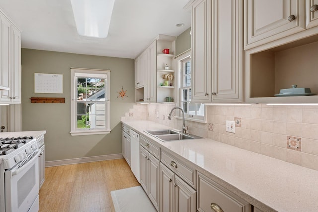 kitchen featuring a sink, open shelves, white appliances, light wood-type flooring, and backsplash