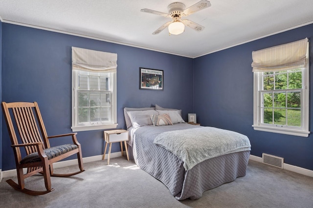 bedroom featuring carpet flooring, ornamental molding, baseboards, and a ceiling fan