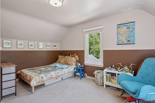 bedroom with lofted ceiling, carpet floors, and baseboards