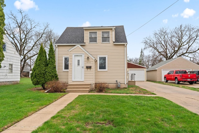 bungalow-style home featuring an outbuilding, a detached garage, a front yard, and roof with shingles
