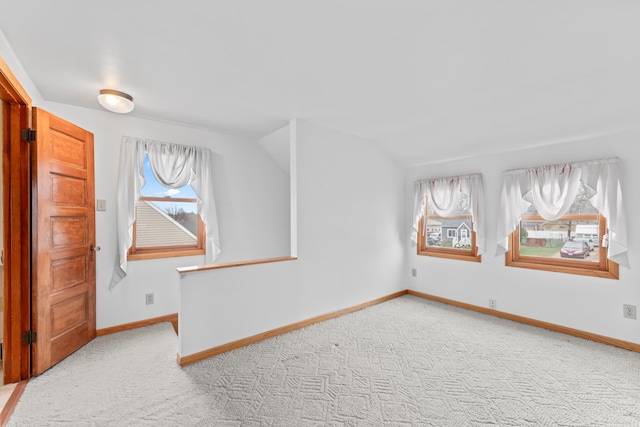 bonus room with lofted ceiling, carpet flooring, and baseboards