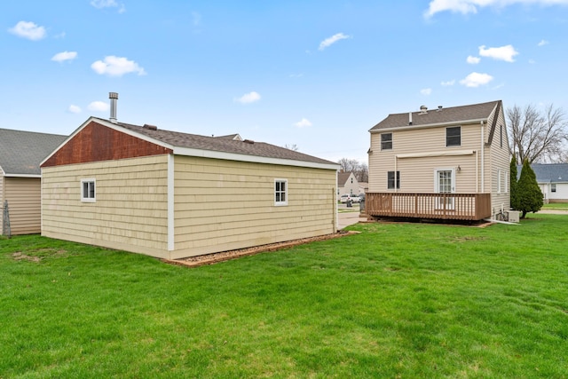 rear view of house featuring a lawn, a wooden deck, and central AC