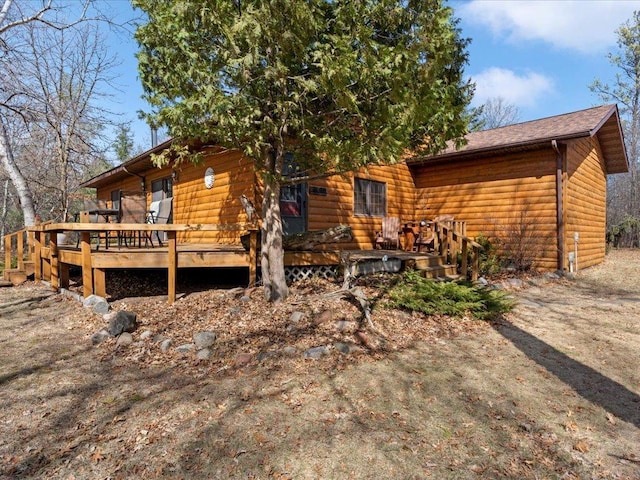 1587 Stallion Rd SW, Pillager, MN 56473 - back of property with a wooden deck and faux log siding