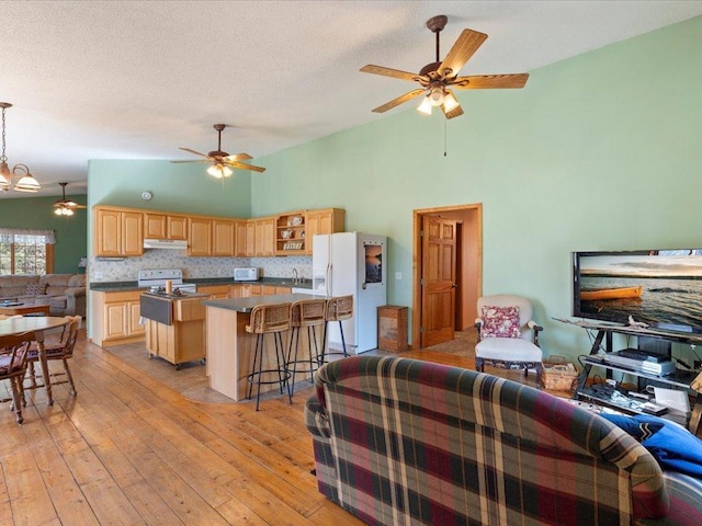 1587 Stallion Rd SW, Pillager, MN 56473 - living room with light wood finished floors, high vaulted ceiling, and ceiling fan with notable chandelier