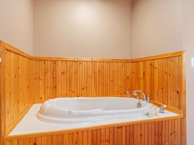 1587 Stallion Rd SW, Pillager, MN 56473 - bathroom featuring wooden walls and a garden tub