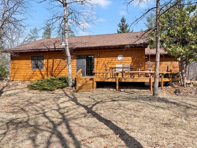 1587 Stallion Rd SW, Pillager, MN 56473 - back of house featuring roof with shingles, faux log siding, and a wooden deck