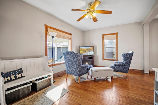 13150 345th Ave, Waseca, MN 56093 - sitting room featuring hardwood / wood-style flooring, a glass covered fireplace, and ceiling fan