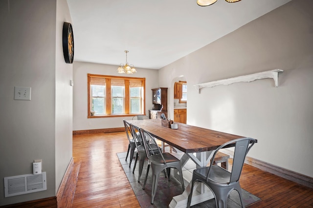 13150 345th Ave, Waseca, MN 56093 - dining area with baseboards, visible vents, arched walkways, and a chandelier