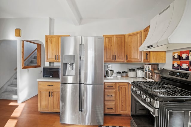 13150 345th Ave, Waseca, MN 56093 - kitchen featuring exhaust hood, stainless steel appliances, light countertops, wood finished floors, and beamed ceiling