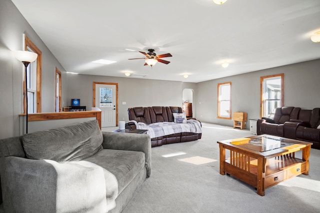 13150 345th Ave, Waseca, MN 56093 - living area featuring a ceiling fan, carpet flooring, and arched walkways
