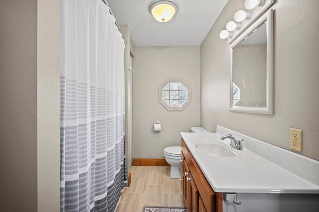 13150 345th Ave, Waseca, MN 56093 - full bathroom with wood finished floors, vanity, a shower with curtain, baseboards, and toilet