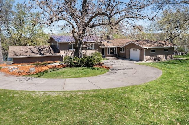 ranch-style home featuring an attached garage, driveway, and a front yard
