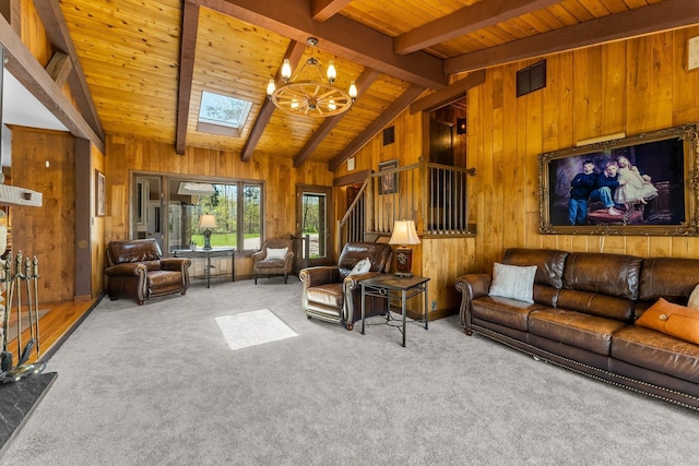 living area featuring wood walls, a chandelier, wooden ceiling, carpet, and a skylight