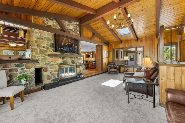 carpeted living room with a stone fireplace, a chandelier, wooden ceiling, and wood walls