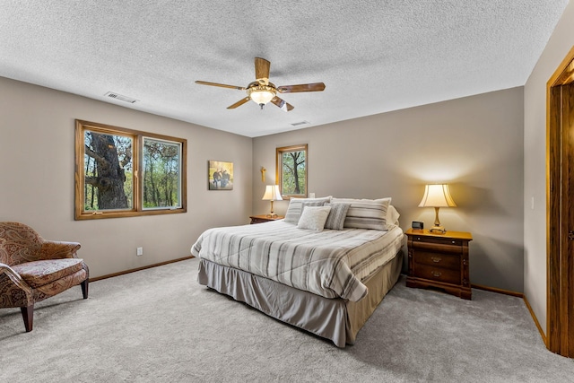 bedroom with carpet floors, baseboards, a ceiling fan, and a textured ceiling