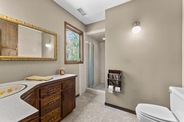bathroom with toilet, a stall shower, tile patterned flooring, vanity, and baseboards
