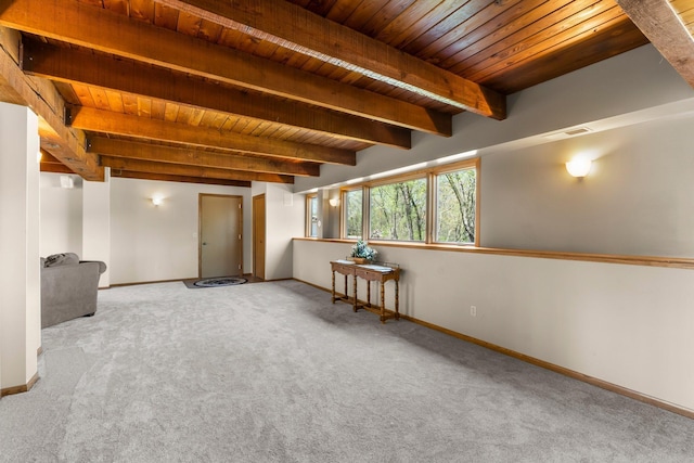 below grade area featuring wood ceiling, carpet flooring, and baseboards