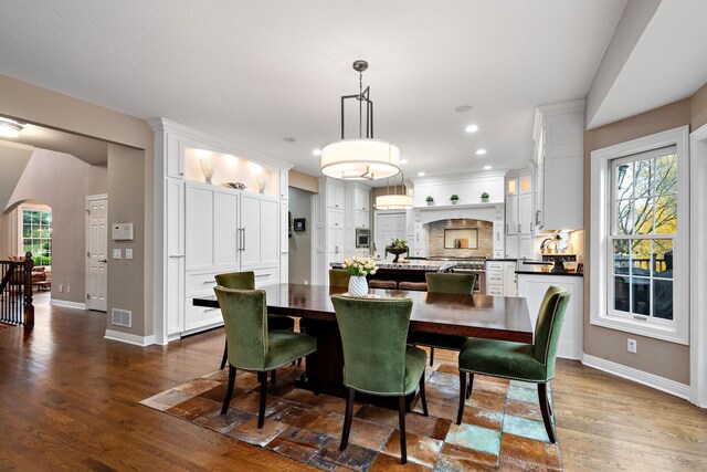 2012 Pine Ridge Dr W, Saint Paul, MN 55118 - dining area with arched walkways, plenty of natural light, dark wood-type flooring, and visible vents