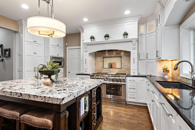 2012 Pine Ridge Dr W, Saint Paul, MN 55118 - kitchen featuring dark stone counters, white cabinets, a sink, high end range, and backsplash