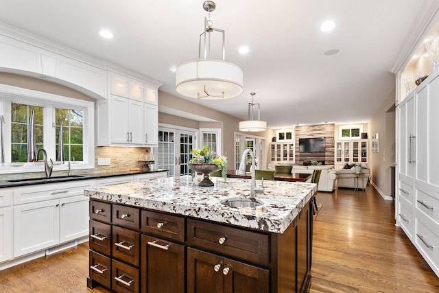 2012 Pine Ridge Dr W, Saint Paul, MN 55118 - kitchen featuring a sink, hanging light fixtures, white cabinets, and dark brown cabinetry