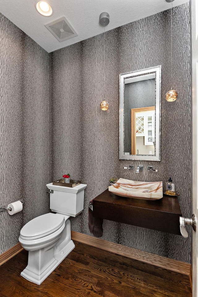 2012 Pine Ridge Dr W, Saint Paul, MN 55118 - half bath featuring baseboards, wood finished floors, and toilet