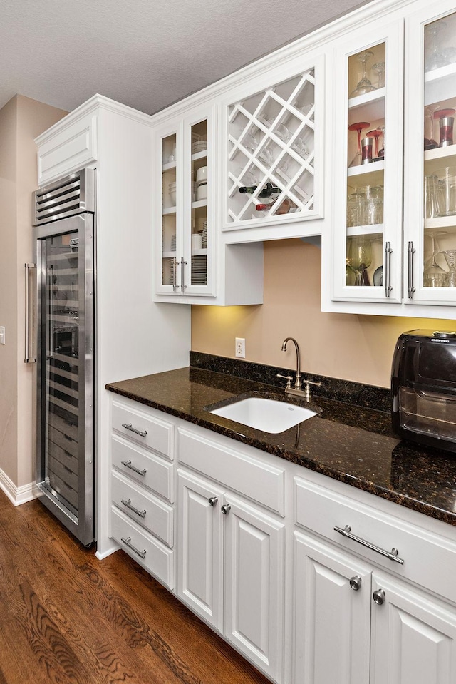 2012 Pine Ridge Dr W, Saint Paul, MN 55118 - bar featuring dark wood-style flooring, beverage cooler, wet bar, and a sink