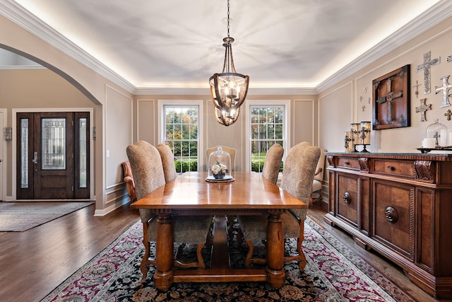 2012 Pine Ridge Dr W, Saint Paul, MN 55118 - dining space with crown molding, dark wood-style flooring, an inviting chandelier, a decorative wall, and arched walkways