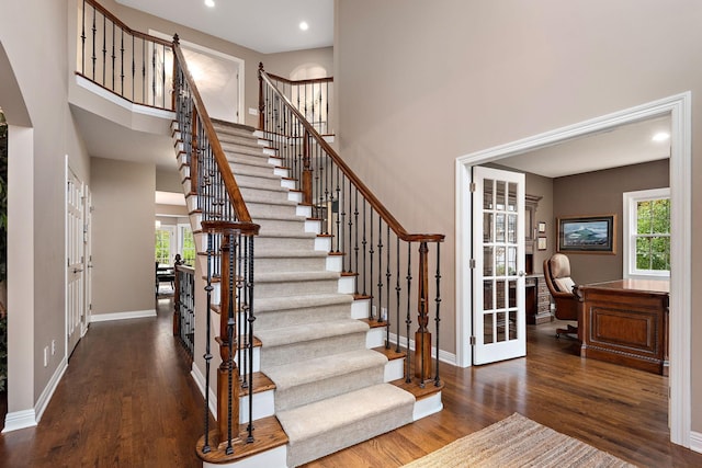 2012 Pine Ridge Dr W, Saint Paul, MN 55118 - stairway featuring baseboards, recessed lighting, wood finished floors, and a towering ceiling