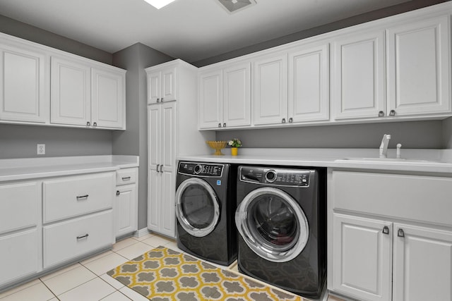 2012 Pine Ridge Dr W, Saint Paul, MN 55118 - laundry room featuring cabinet space, a sink, light tile patterned floors, visible vents, and washing machine and dryer