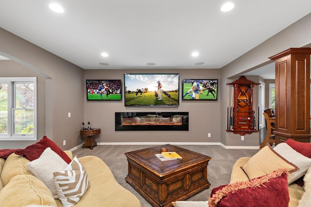 2012 Pine Ridge Dr W, Saint Paul, MN 55118 - carpeted living room featuring arched walkways, baseboards, recessed lighting, and a wealth of natural light
