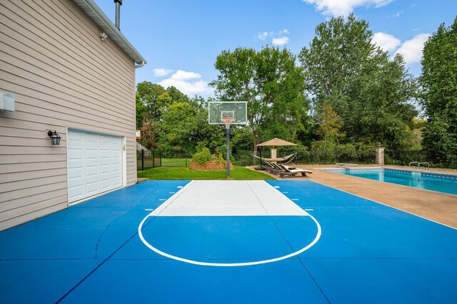 2012 Pine Ridge Dr W, Saint Paul, MN 55118 - view of basketball court with a lawn, fence, basketball hoop, and a fenced in pool