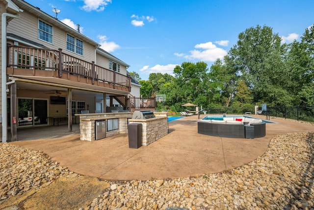 2012 Pine Ridge Dr W, Saint Paul, MN 55118 - exterior space featuring fence, a wooden deck, a patio, a fenced in pool, and exterior kitchen
