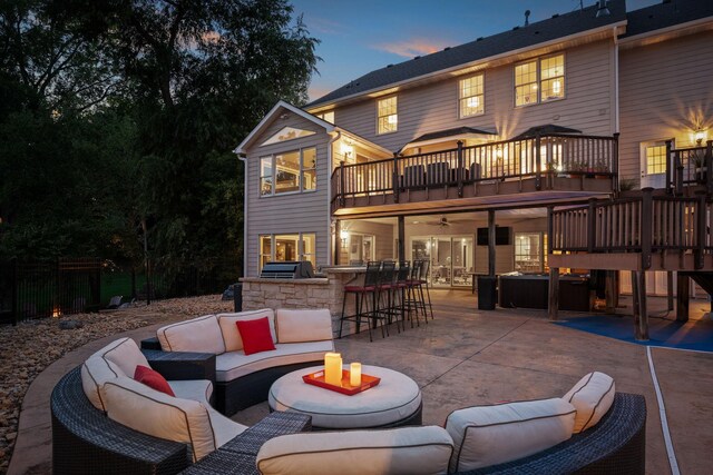 2012 Pine Ridge Dr W, Saint Paul, MN 55118 - back of property at dusk with a balcony, a patio, outdoor dry bar, an outdoor living space, and a ceiling fan