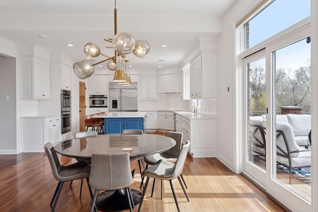dining area featuring recessed lighting, baseboards, and wood finished floors