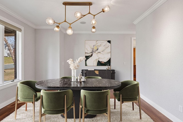 dining space featuring baseboards, ornamental molding, and wood finished floors