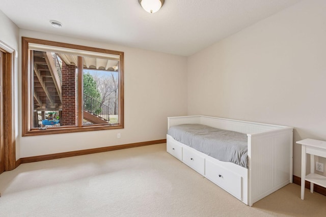 bedroom featuring baseboards and carpet floors