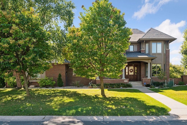 view of front of home with a front yard and brick siding