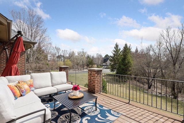 view of patio featuring outdoor lounge area and a balcony