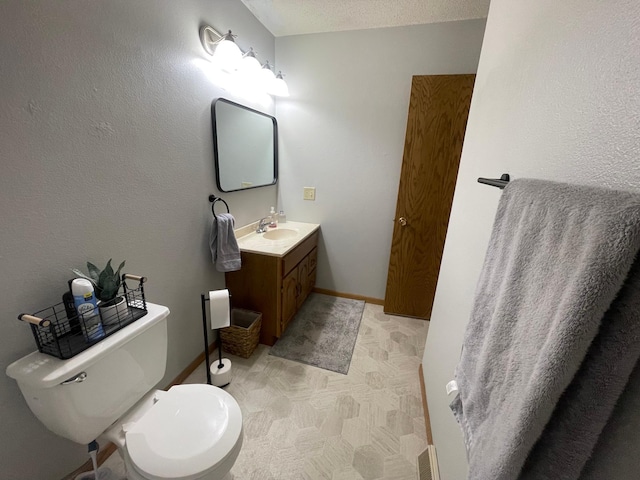 301 1st St, Adrian, MN 56110 - bathroom with baseboards, vanity, and toilet