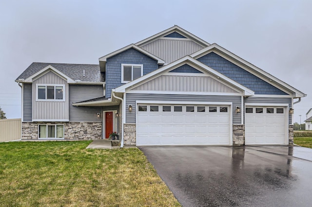 15141 Partridge St NW, Andover, MN 55304 - view of front of property with asphalt driveway, an attached garage, stone siding, and a front yard