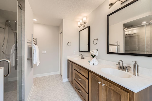 15141 Partridge St NW, Andover, MN 55304 - full bathroom featuring a stall shower, a textured ceiling, double vanity, and baseboards