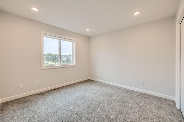 15141 Partridge St NW, Andover, MN 55304 - carpeted spare room featuring baseboards and recessed lighting