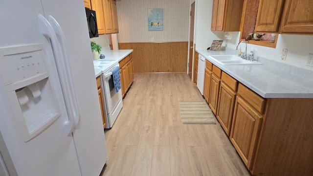1509 2nd Ave SW, Austin, MN 55912 - kitchen featuring light wood-style flooring, a wainscoted wall, a sink, white appliances, and light countertops