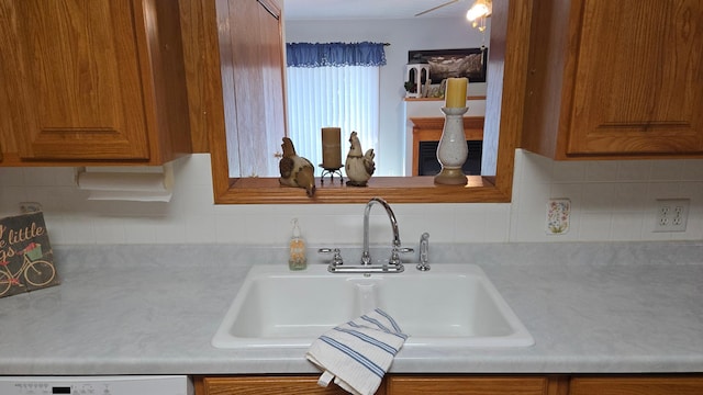 1509 2nd Ave SW, Austin, MN 55912 - details with light countertops, brown cabinetry, dishwashing machine, and a sink