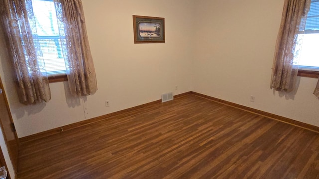 1509 2nd Ave SW, Austin, MN 55912 - empty room featuring dark wood finished floors, baseboards, and visible vents