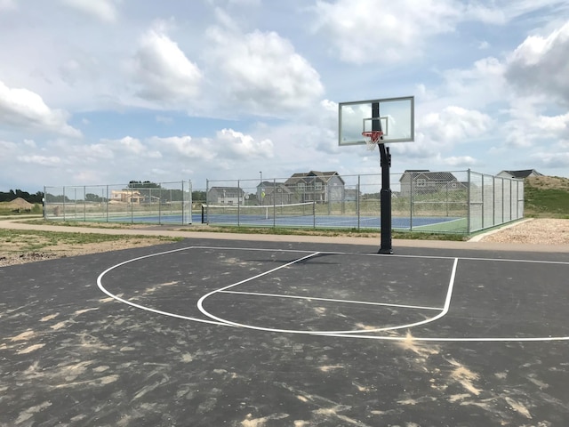 view of sport court with community basketball court, a tennis court, and fence