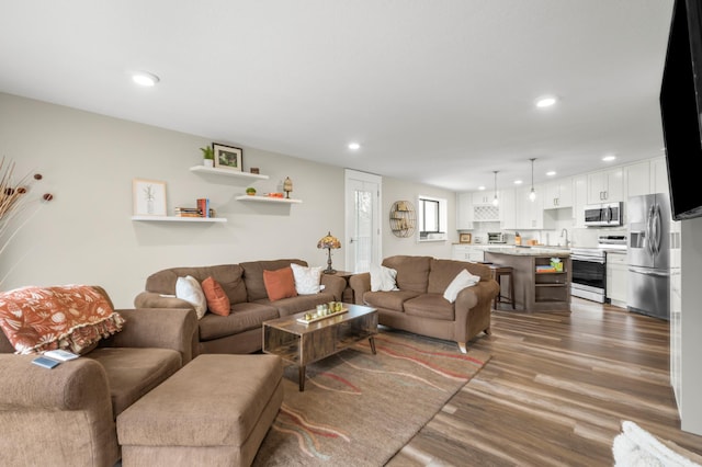 living area with wood finished floors and recessed lighting