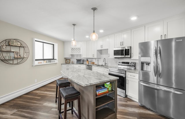 kitchen featuring appliances with stainless steel finishes, open shelves, a kitchen island, recessed lighting, and white cabinetry