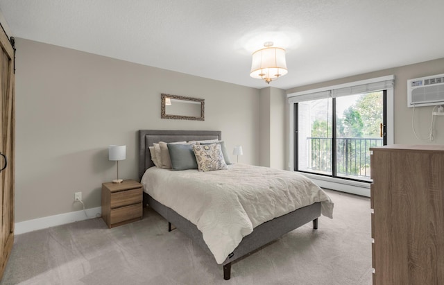 bedroom featuring a baseboard radiator, carpet flooring, baseboards, and a barn door