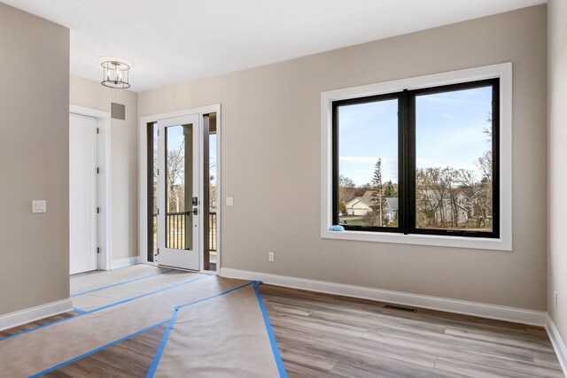 4729 Linden Cove Ln, Savage, MN 55378 - entrance foyer featuring baseboards, visible vents, and wood finished floors